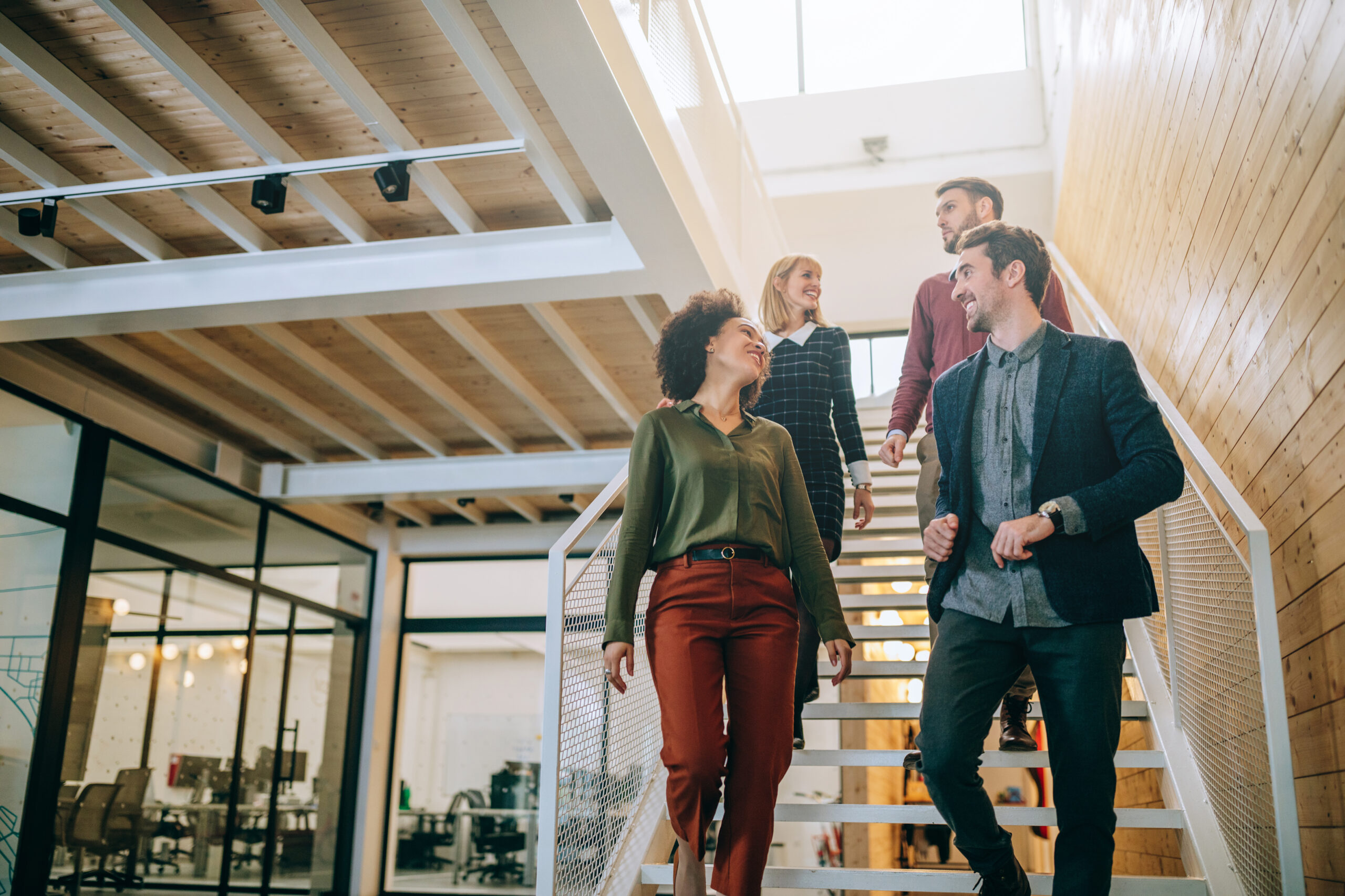 Group,Of,Diverse,Coworkers,Walking,Down,The,Stairs,In,An